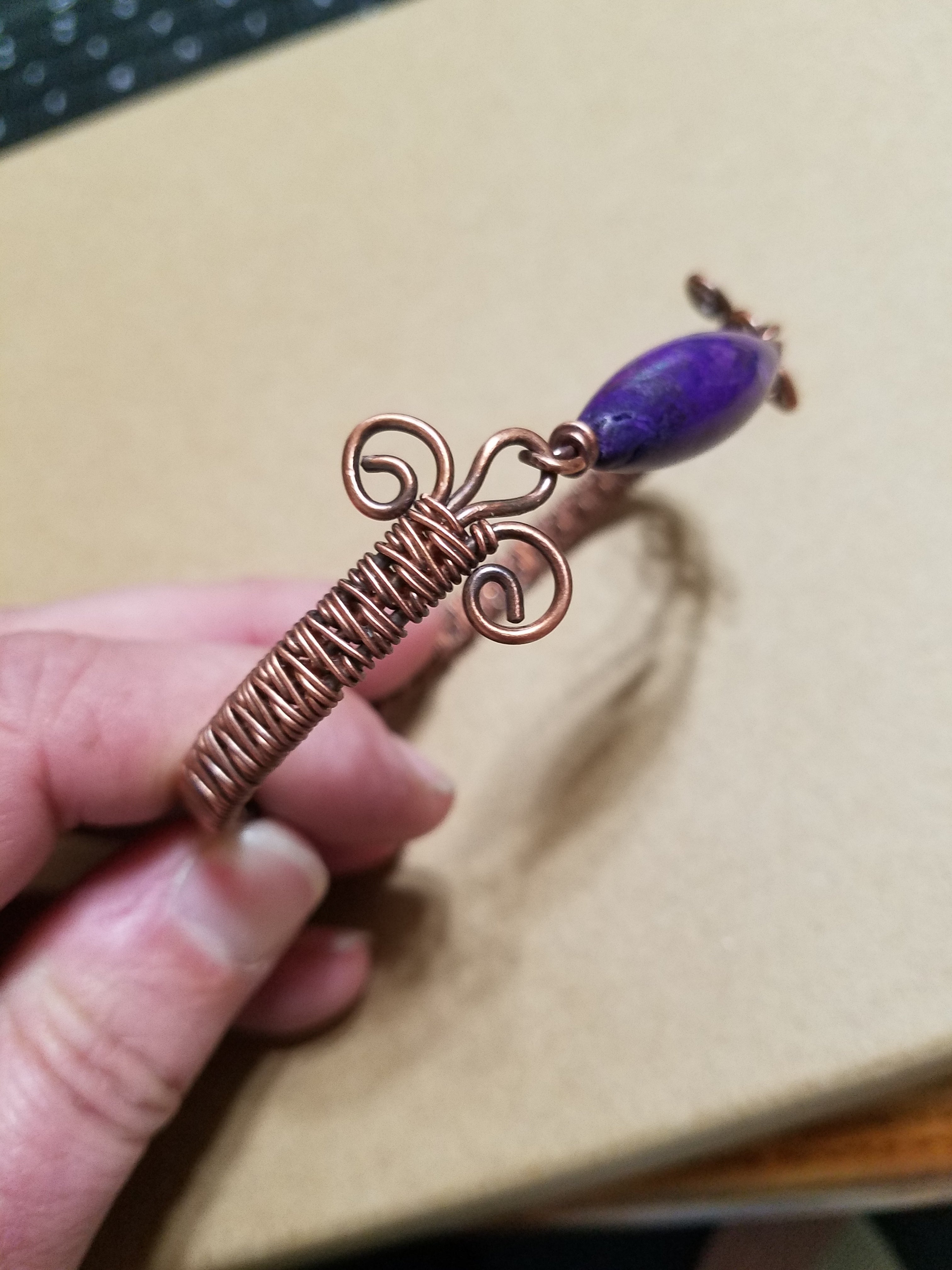 Slender woven copper bracelet with gemstone bead clasp
